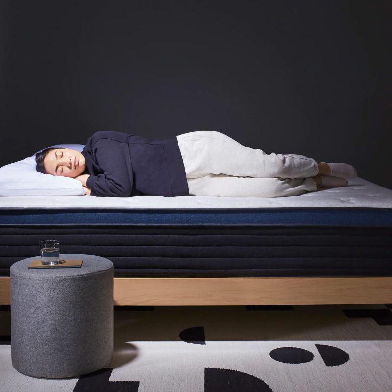 A woman sleeping on the Helix Midnight Luxe memory foam mattress.