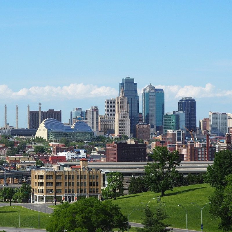 A downtown panorama of Kansas City, Missouri with a sprawling park in the foreground