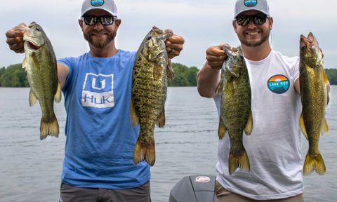 Two men holding two game fish caught on a Lake Hop trip.