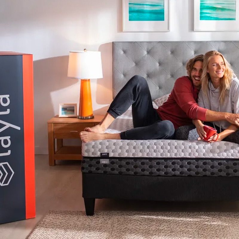 A couple hangs out on their Layla Memory Foam Mattress