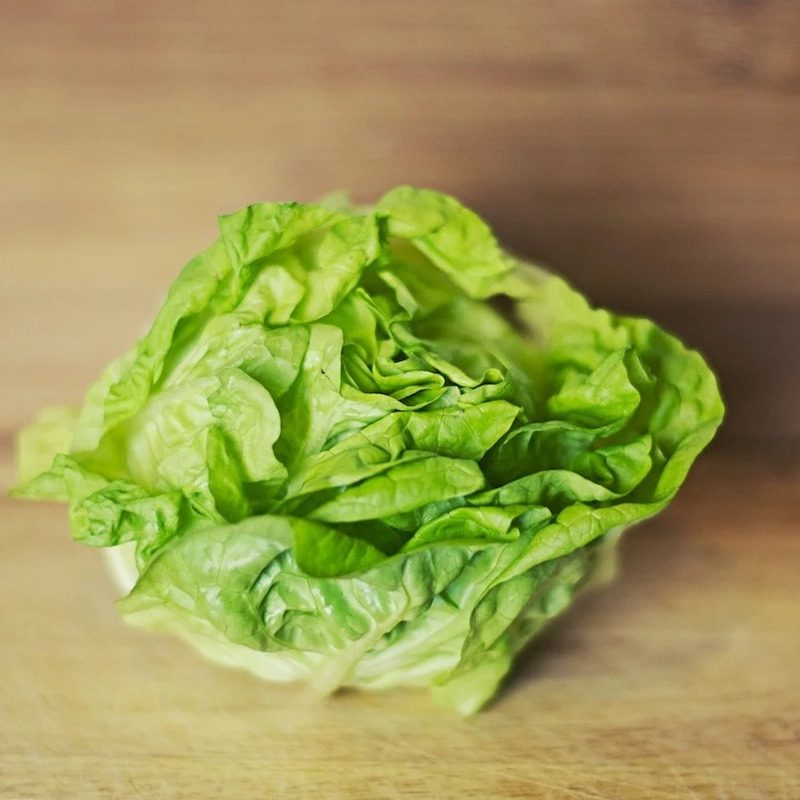 Butter lettuce on a board.