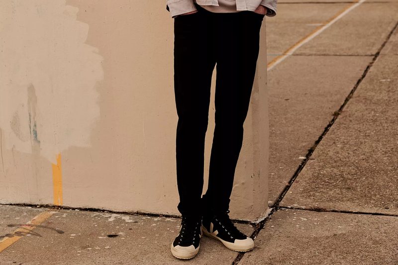 Madewell Slim Jeans in black on a model.