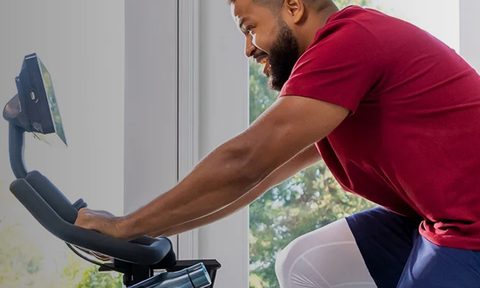 Man with a beard riding an exercise bike