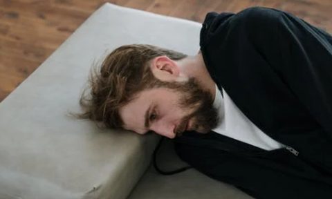 Man lying down on a daybed.