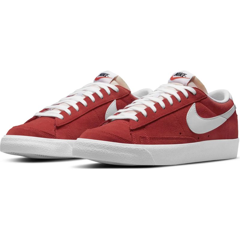 A pair of red nike blazer sneakers sit against a white background.