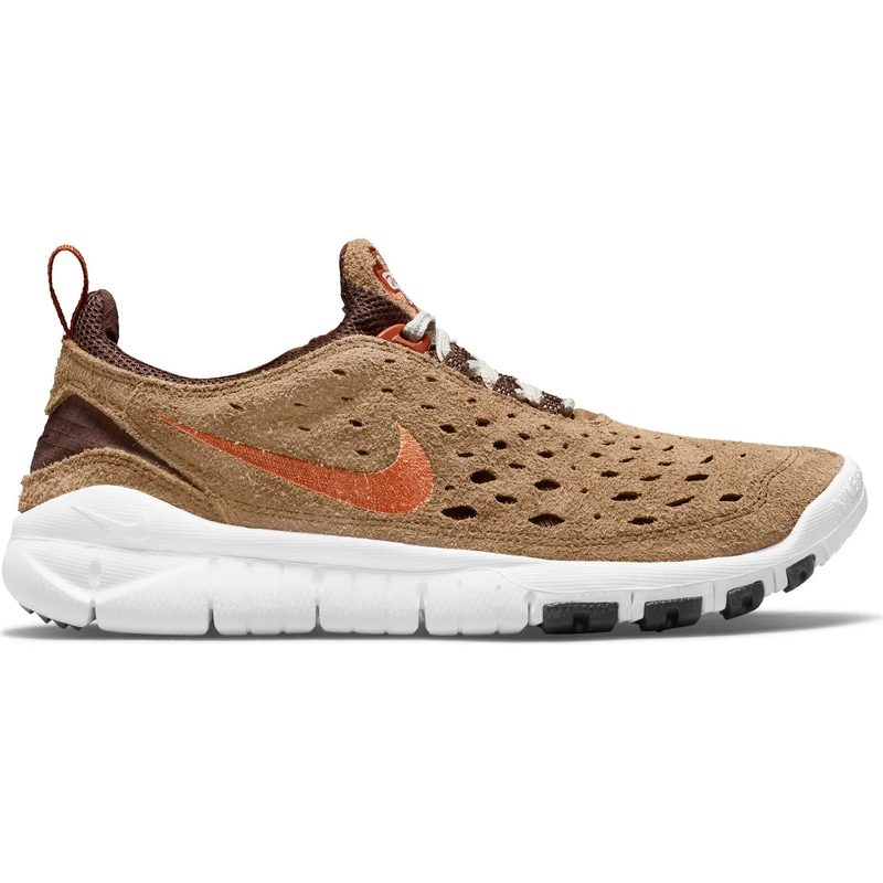 Nike free run trail sneaker is pictured from the side on a white background.