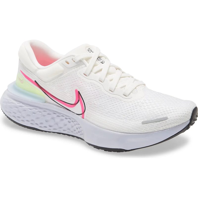 White Nike sneaker with a pink swoosh on a white background.