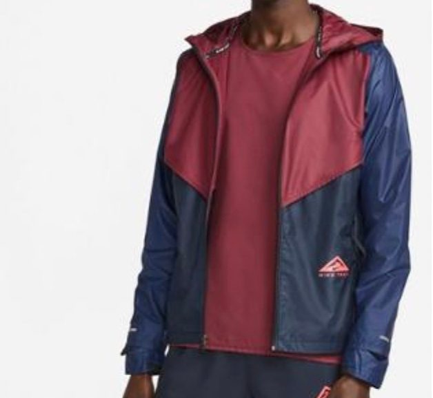 Nike windrunner jacket on a model with a grey background.