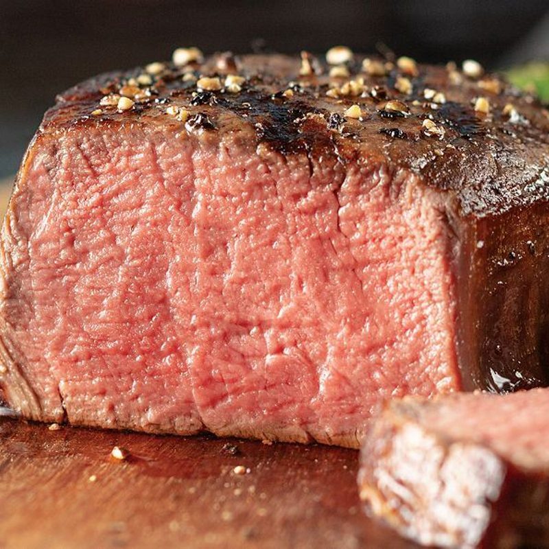 A sliced filet mignon sits on a table.