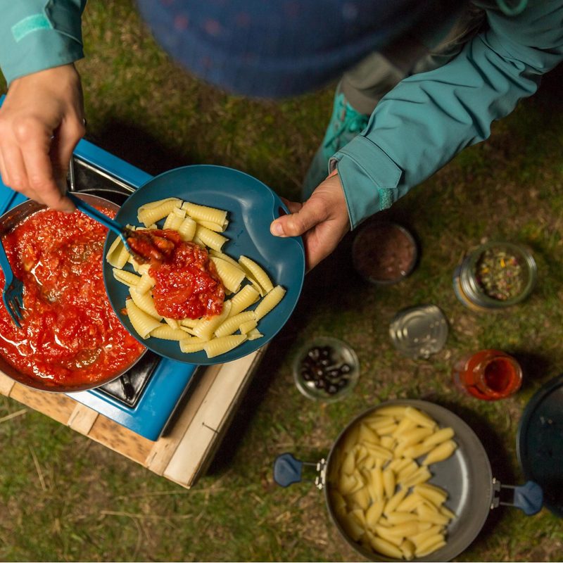 Plating pasta on Quechua camp plate.