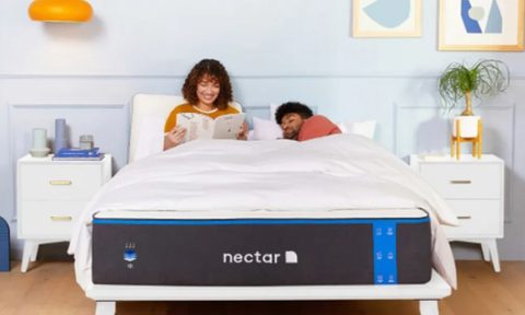 Two people on a Nectar Memory Foam mattress, one sleeping and the other reading.