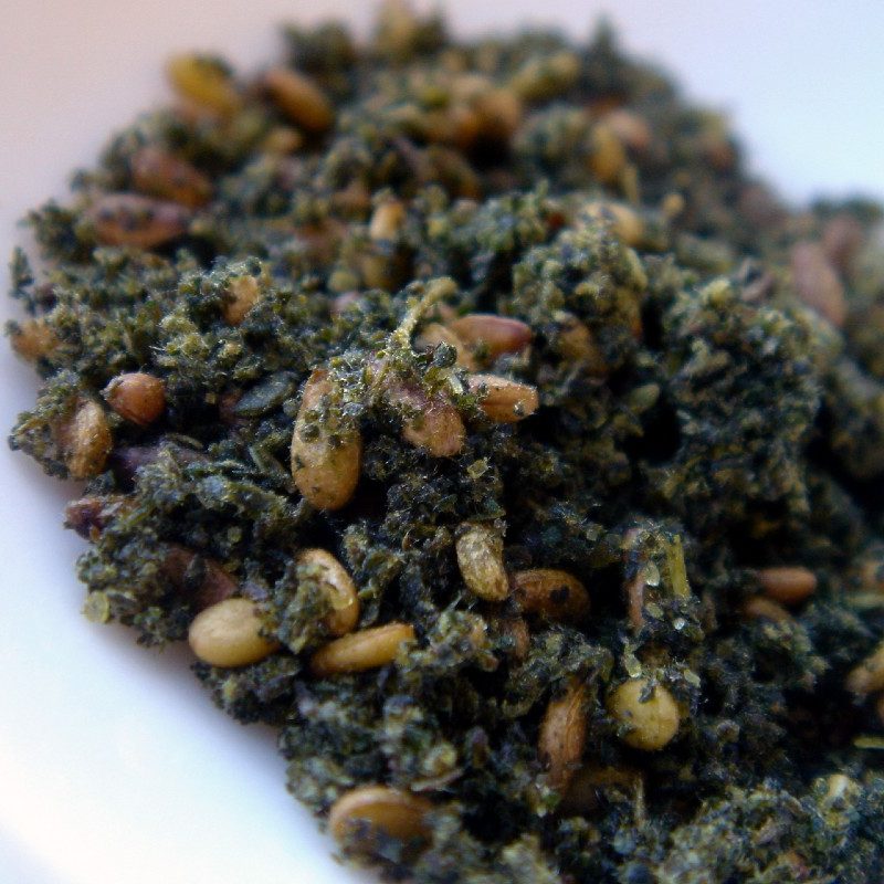 Closeup image of za'atar spice mixture, a blend of herbs, sumac, sesame. and salt.
