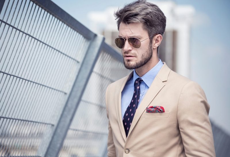 Man in a tan suit on bridge