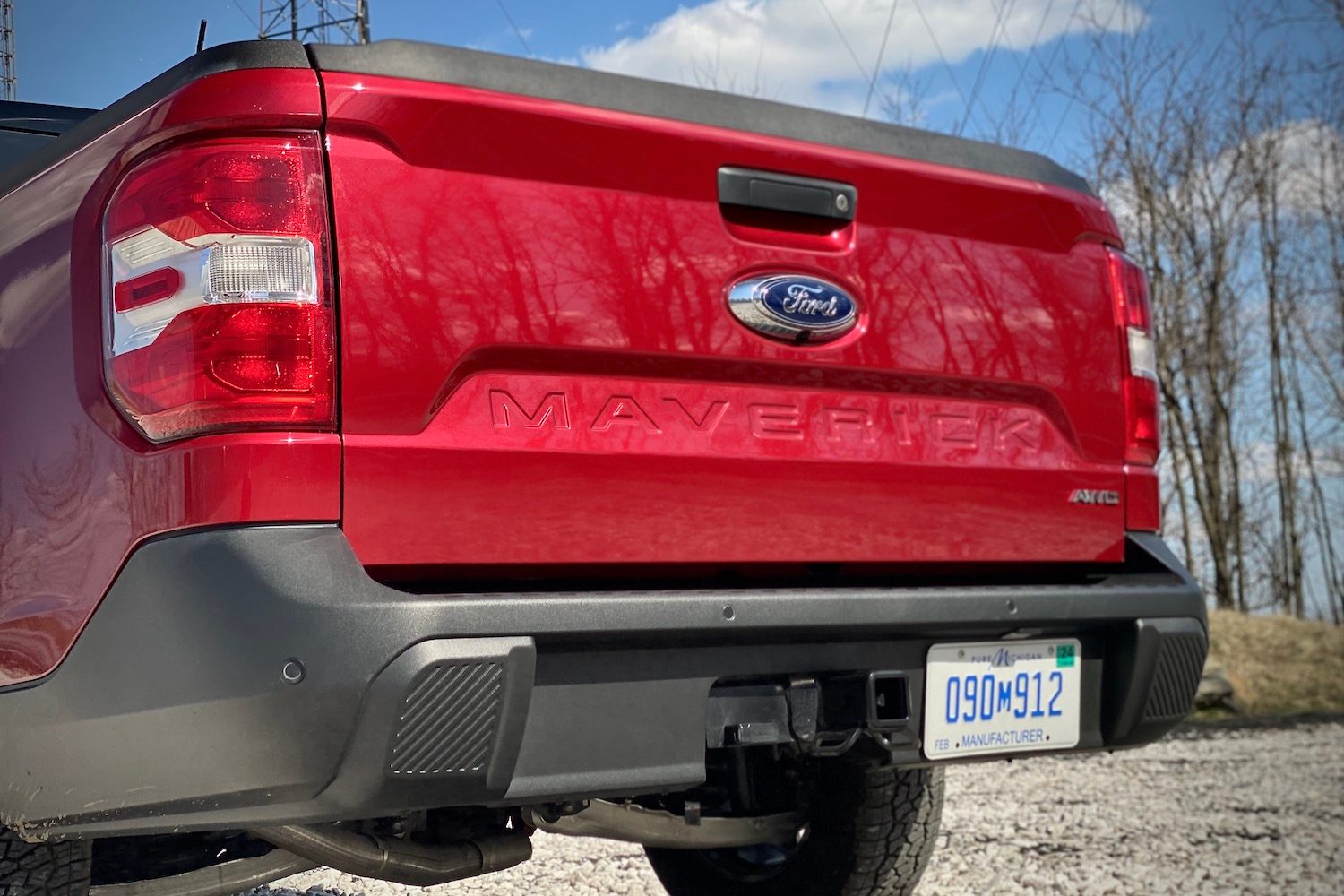 2022 Ford Maverick rear end close up of tailgate and rear badging in a gravel parking lot.