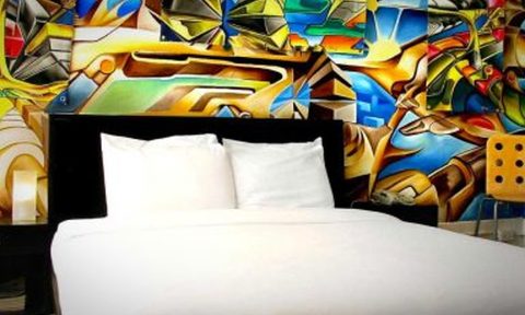 Art adorns the headboard above a hotel bed
