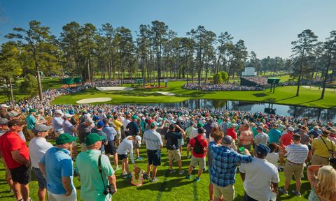 Fans watch golfers play in the Master's Tournament at the Augusta National Golf Club.