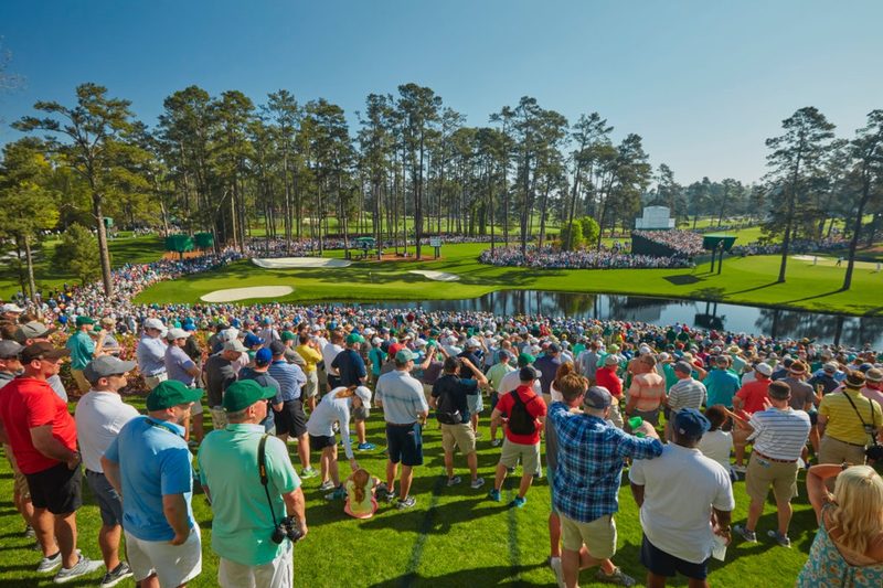 Fans watch golfers play in the Master's Tournament at the Augusta National Golf Club.