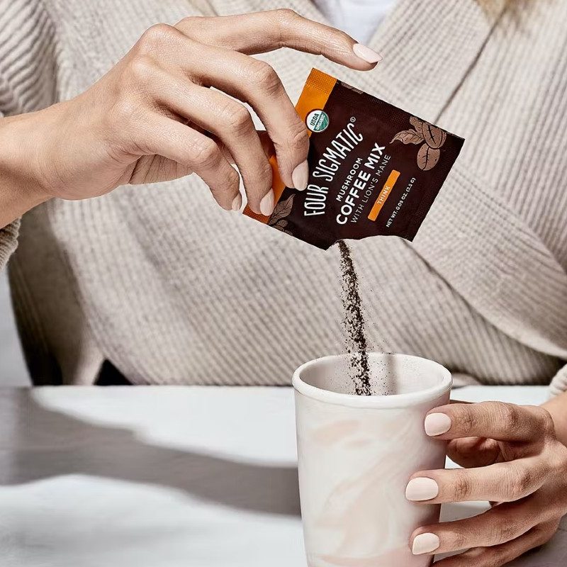 Four Sigmatic Mix being poured into a coffee cup.