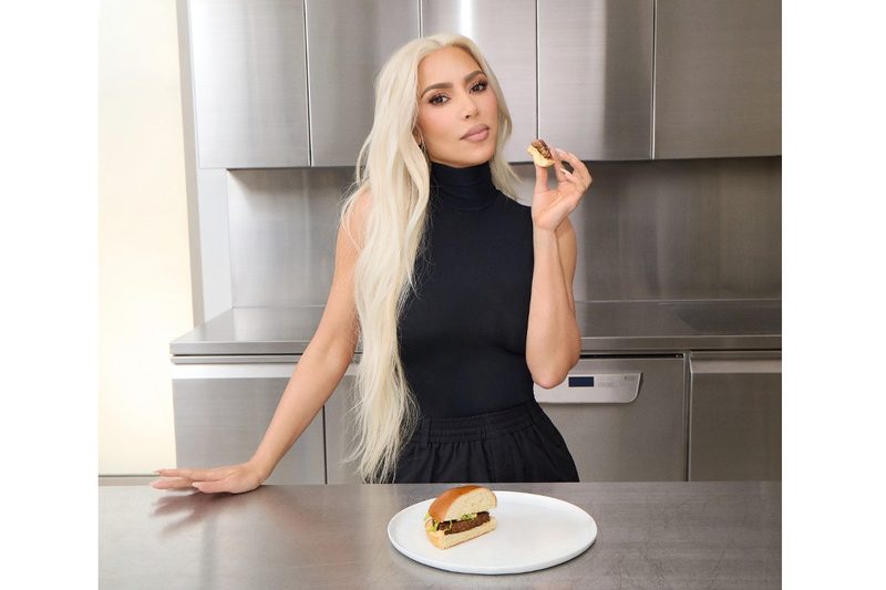 Kim Kardashian modeling with a Beyond Meat burger