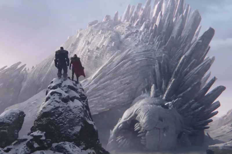 Korg (left) and Thor (right) silhouetted from behind, standing over the remains of a dead god