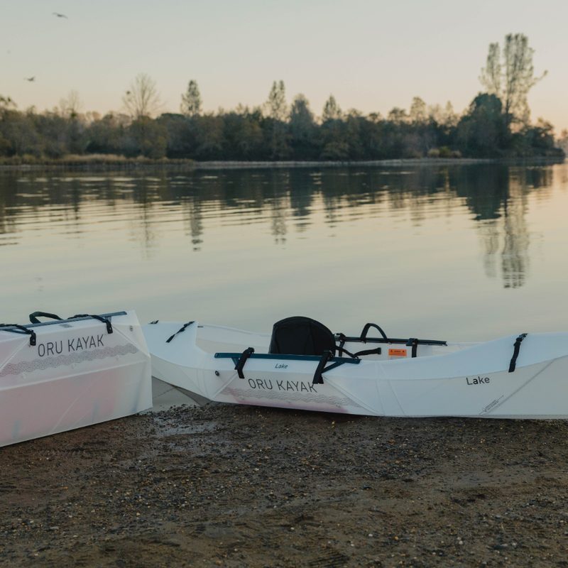 Oru Lake foldable kayak on a river edge