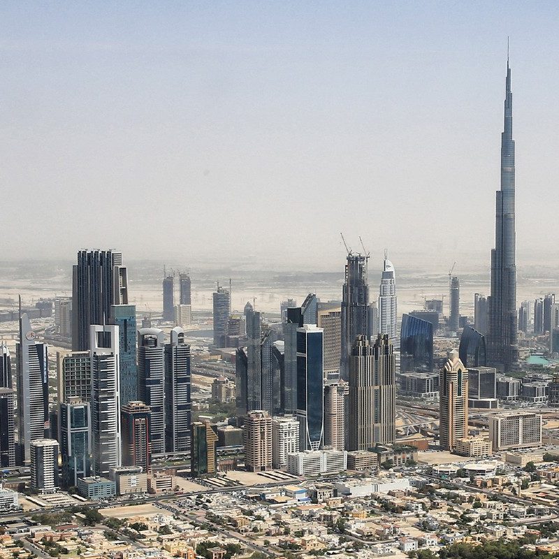 Hazy skyline of Downtown Dubai viewed from a helicopter.