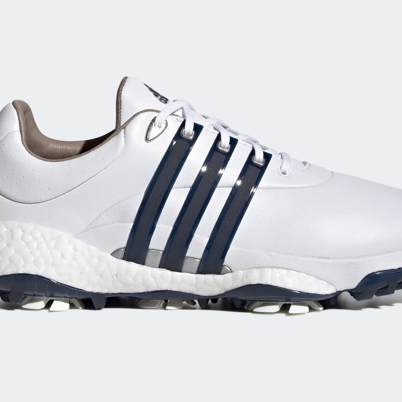Adidas white golf shoe with blue stripes.