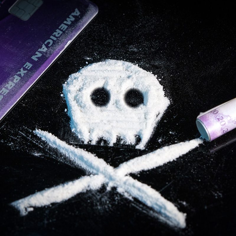 Close-up of a cocaine "skull and crossbones" on a black table