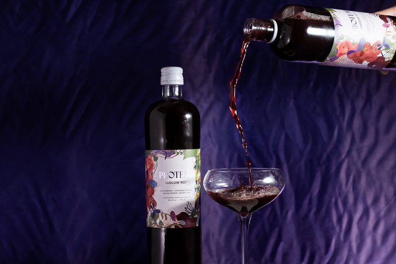 Proteau botanical drink being poured into a glass