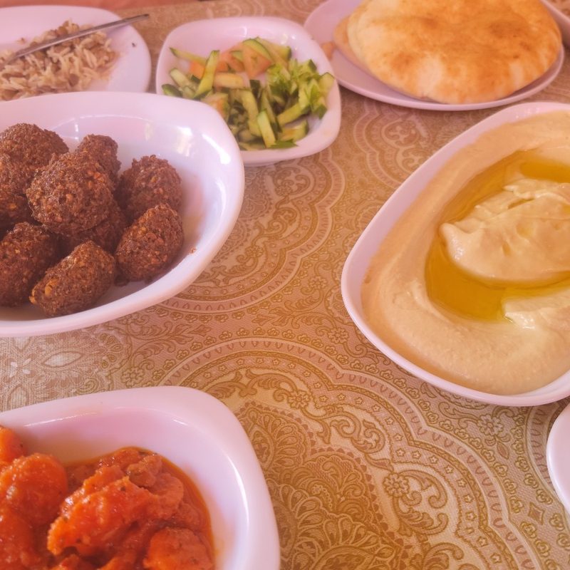 A table full of food at Hummus Abu Elias in Akko, Israel.
