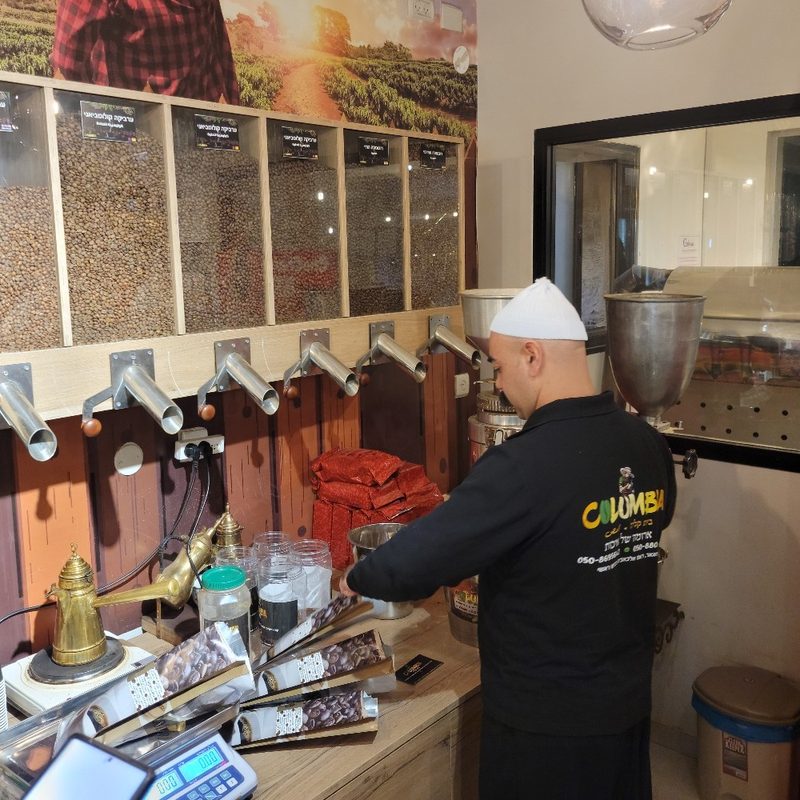 A man prepares Arabic Coffee at Columbia market in Maghar, Israel.