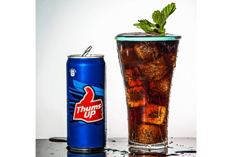 A can and glass of Thums Up