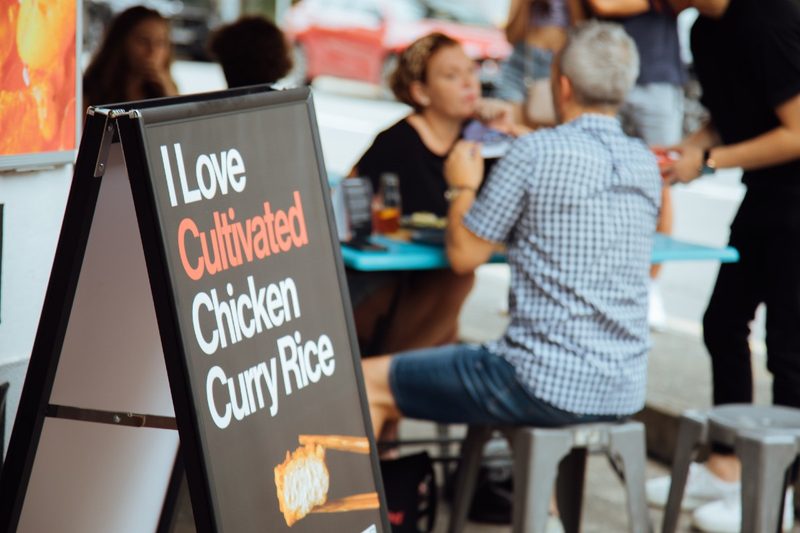 A sign at Mr. Loo's reading 'I Love Cultivated Chicken Curry Rice.'