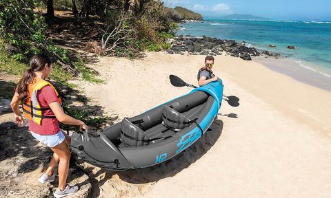 INTEX Sport Series Tacoma K2 carried by a man and a woman at a beach