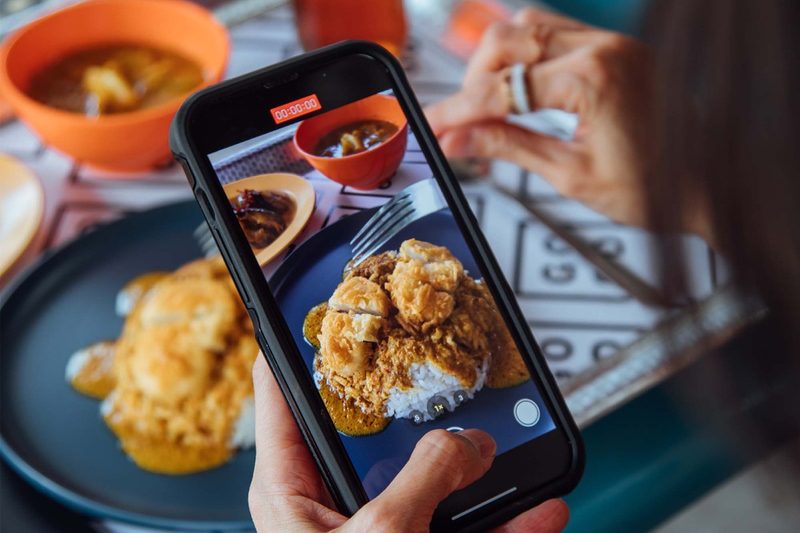 Loos curry rice pictured on and under an iphone.