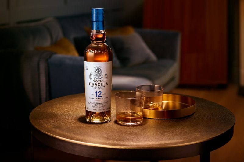 Royal Brackla Scotch bottle next to neat glasses of Scotch whisky