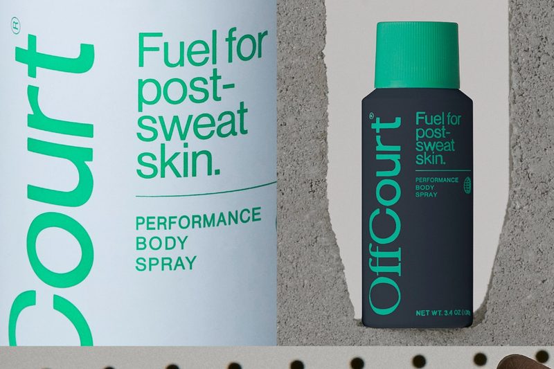 A close-up of two cans of OffCourt Performance Body Spray.