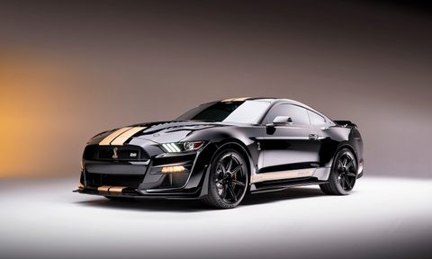 2022 Shelby GT500-H from the front driver's side in a studio under a large central light with a gray gradient background.