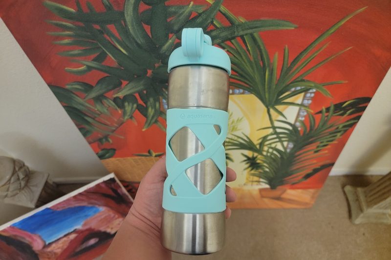 A writer holds the Aquasana Stainless Steel Insulated Clean Water Bottle.