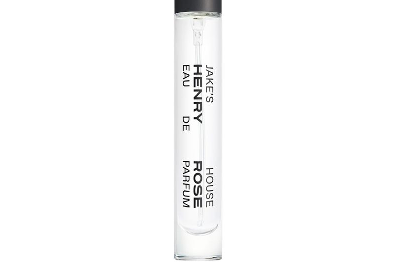 A close-up of a travel size bottle of Henry Rose fragrance.