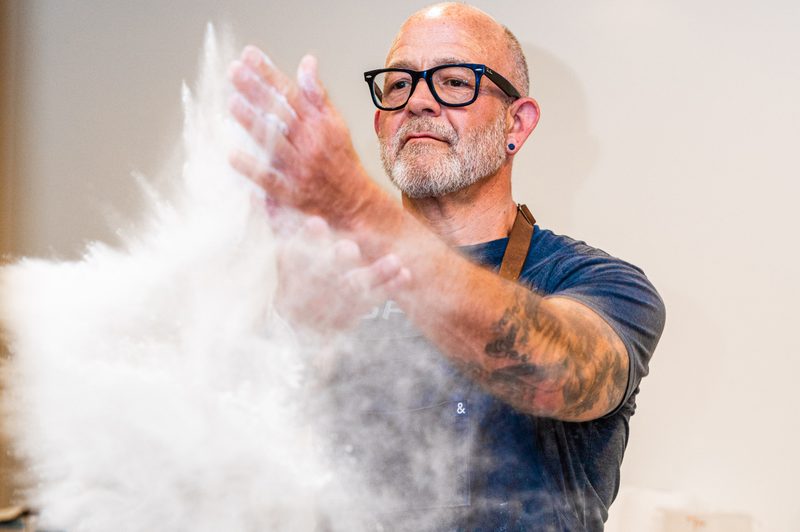 Chef Ted Cizma making a pizza.