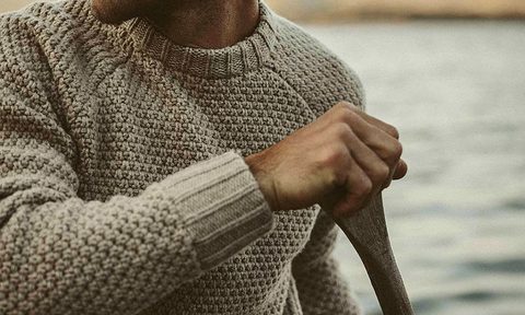 Man canoeing in a pullover sweater