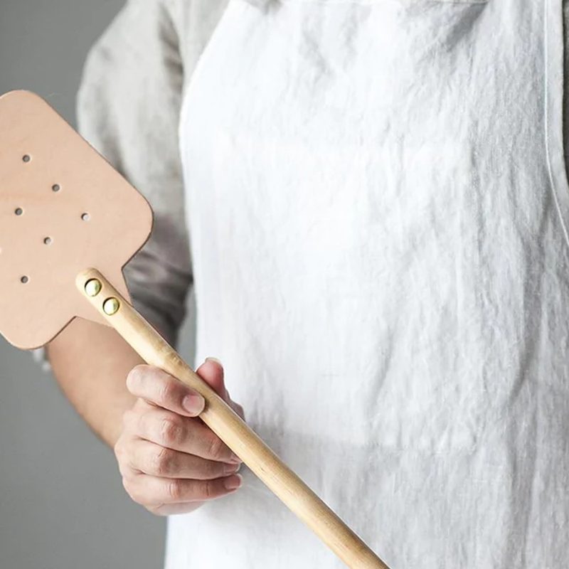 Someone holds the Farmhouse Pottery Huntsman Fly Swatter.