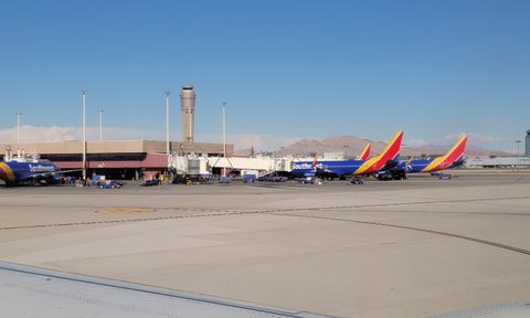 A group of airplanes are parked at the airport.