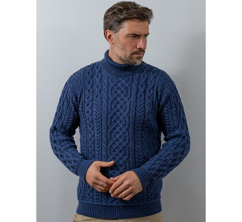 Man wearing a blue cable knit turtleneck sweater