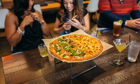 Customers enjoy Columbus-style pizza.