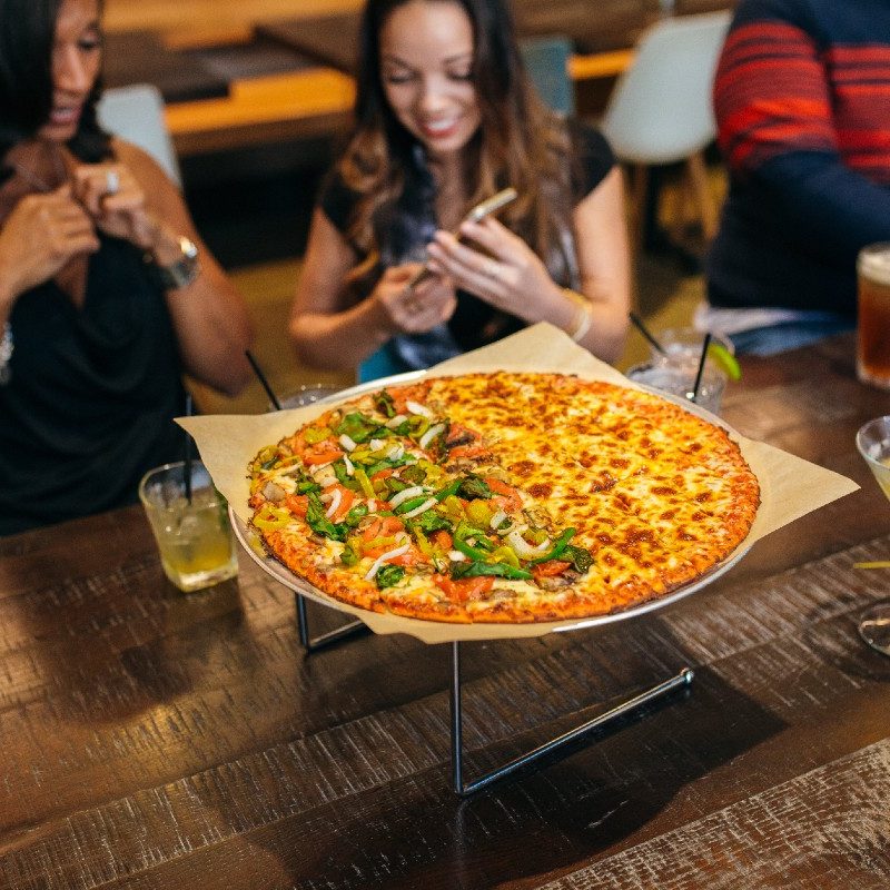 Customers enjoy Columbus-style pizza.