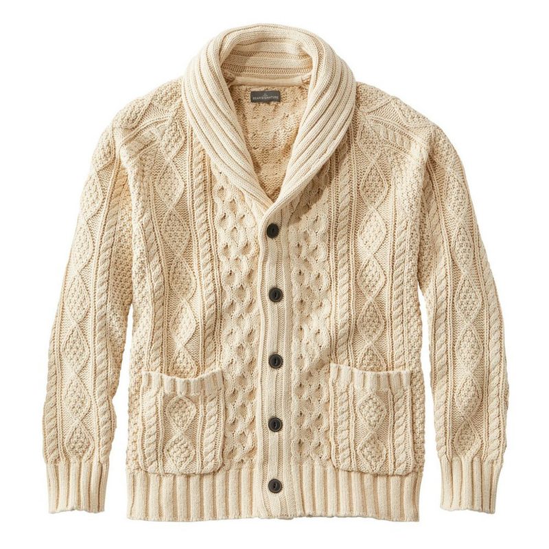 A cream colored cable knit shawl collar cardigan.