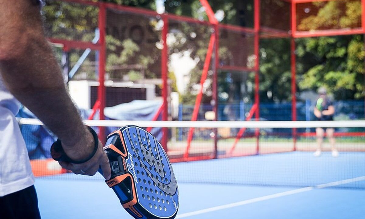 Player holding a padel paddle.