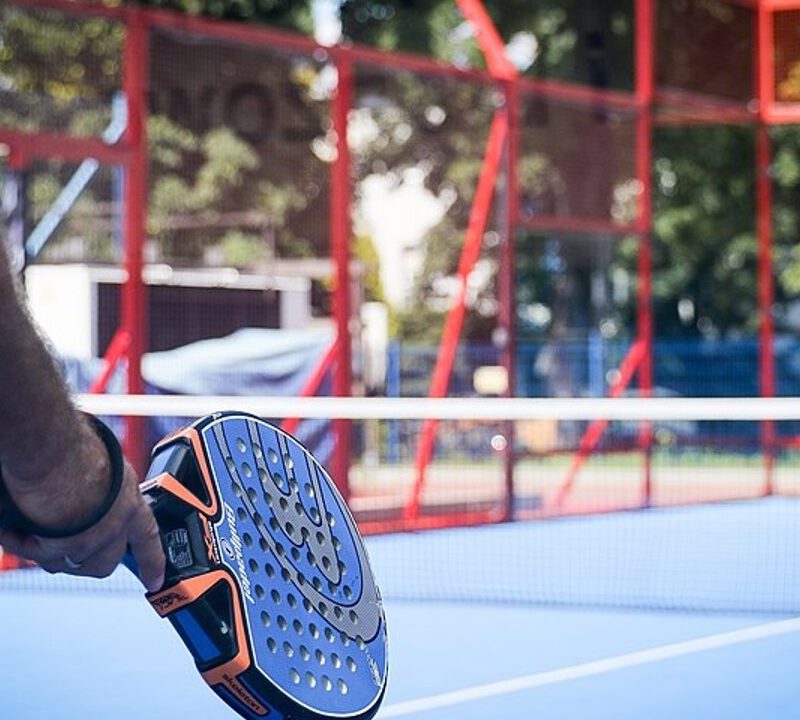 Player holding a padel paddle.
